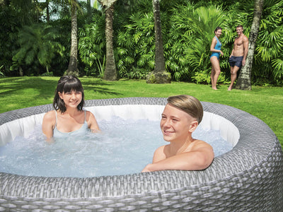  Lay-Z-Spa Honolulu AirJet in een tuin, ideaal voor ontspanning met warm water en bubbels.